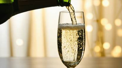 Champagne being poured into a champagne glass close up