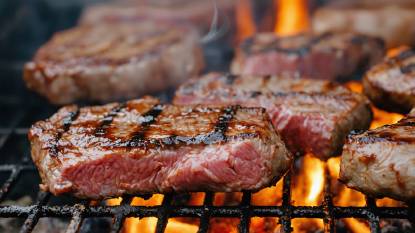 Meat cooking on an outdoor barbecue grill