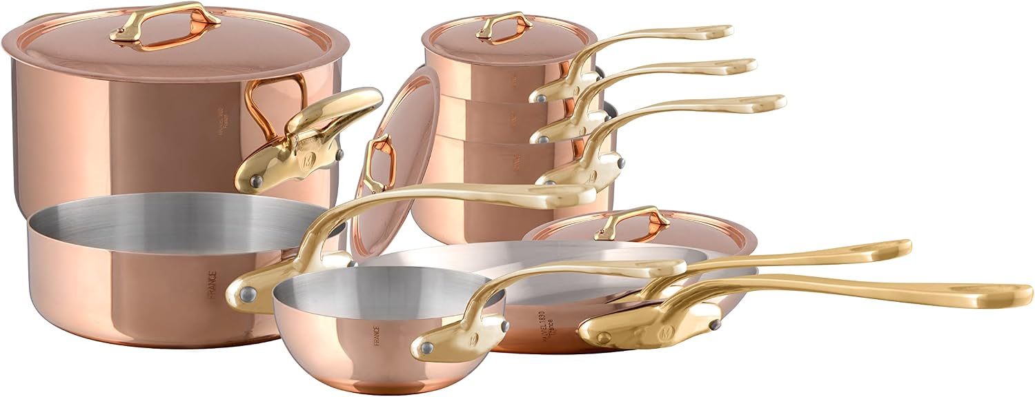 Mauviel M'Heritage M'200 B 12-Piece Copper Cookware Set with polished brass handles displayed on a kitchen counter