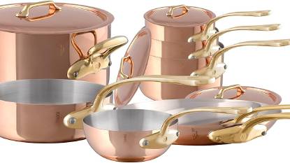 Mauviel M'Heritage M'200 B 12-Piece Copper Cookware Set with polished brass handles displayed on a kitchen counter
