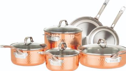 Viking 3-Ply Hammered Copper Clad 10-Piece Cookware Set on a stovetop with copper pots and glass lids