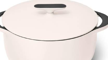 Caraway enameled cast iron Dutch oven in a cream color on a modern kitchen stovetop