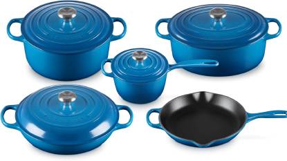 Le Creuset Signature 9-Piece Cookware Set in Marseille blue displayed on a kitchen countertop, showing the full collection of Dutch ovens, braiser, saucepan, and skillet