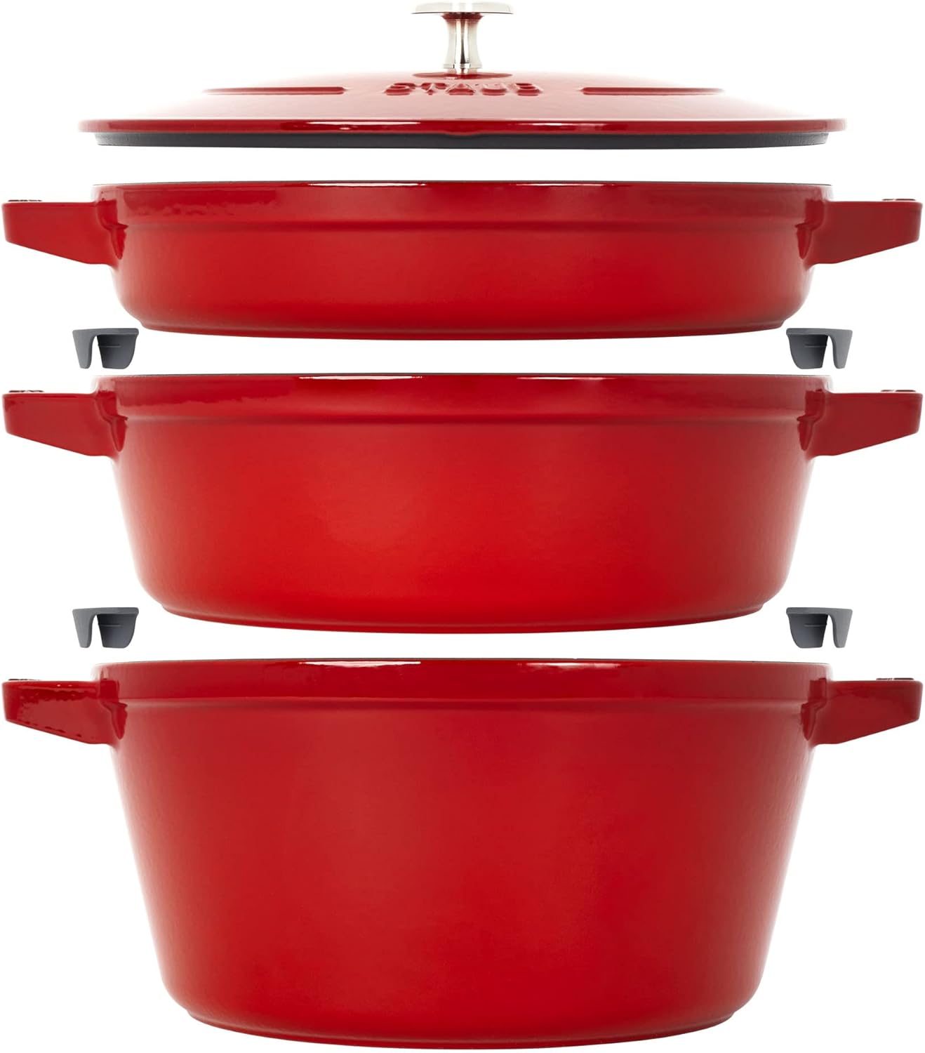 STAUB Stackable Dutch Oven 4-Piece Set nested together on a kitchen counter, showing the cocotte, braiser, and grill pan with the universal lid