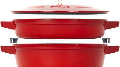 STAUB Stackable Dutch Oven 4-Piece Set nested together on a kitchen counter, showing the cocotte, braiser, and grill pan with the universal lid