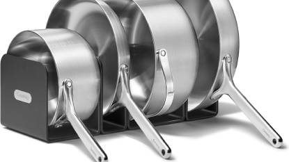 Caraway 5-Ply Stainless Steel Cookware Set arranged on a modern kitchen counter with the magnetic storage rack.